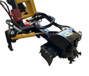 Close-up of a yellow Paddock Swinging Stump Grinder Attachment (suits STRKL1200) with hydraulic hoses and a black rotating component, isolated on white. Brand: Paddock.