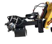 Close-up of a Paddock Swinging Stump Grinder Attachment—suits STRKL1200—showing hydraulic hoses, metal parts, and a rotating mechanism by Paddock, isolated on white.