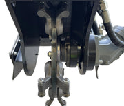Close-up of the Paddock Swinging Stump Grinder Attachment for STRKL1200, displaying its metal components, bolts, hydraulic hoses, and rotating disc within a black frame—all set against a white background.