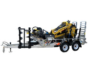 A Paddock Mini Loader is secured on a Paddock Mini Loader & Excavator Alloy Equipment Trailer, featuring dual axles, heavy-duty construction, mounted auger attachments on the side, and a rear metal ramp.
