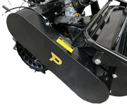 Close-up of the Paddock Walk Behind Flail Mower 12HP - 900mm in black, featuring a visible engine and yellow P logo. This heavy-duty mower, ideal for vegetation control, sits on concrete with a yellow warning label above its metal cover.