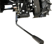 Close-up of a black metal gear shift lever near the rear wheel of the Paddock Walk Behind Flail Mower 12HP - 900mm, labeled with gear positions 1, N, 2, and R. The mower is by Paddock and shown against a white background.