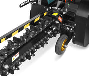 Close-up view of the Paddock Walk Behind Trencher with Guide Wheel, featuring a rotating chain with digging teeth, yellow and black safety stripes, a support wheel, and powered by a reliable Briggs & Stratton engine. Brand: Paddock.