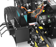 Close-up of the Paddock Walk Behind Trencher with Guide Wheel by Paddock, showing exposed engine components, wires, warning labels, large tires, and part of the toothed rotating mechanism.