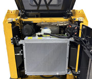 The image displays the open engine compartment of a Paddock Tracked Cabin Loader Pro with a 40hp Perkins turbo diesel engine. Raised top and side panels provide access to the radiator, hoses, metal components, and wiring inside the sturdy yellow frame.