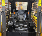 The image shows the operator seat and control joysticks inside a Paddock Tracked Cabin Loader Pro (40hp Perkins Turbo Diesel Engine, Ex Demo), with mesh side panels. Construction equipment shelves appear in the background.