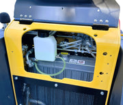 Close-up of the Paddock Tracked Mini Loader with a 35hp Kubota diesel engine, showing an open panel that reveals interior components like a white fluid reservoir, metal pipes, and radiator—highlighting key hydraulic and mechanical features.